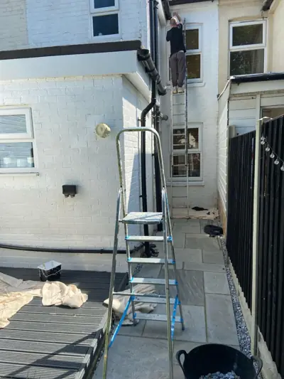 Side of a house during exterior painting