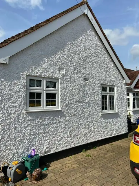 Roughcast bungalow repainted white