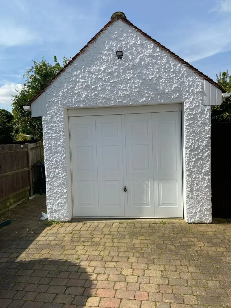 Rendered garage repainted white