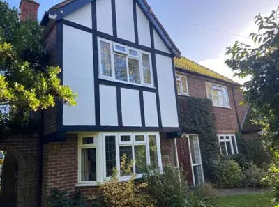 Tudor-style house with black and white exterior repainted