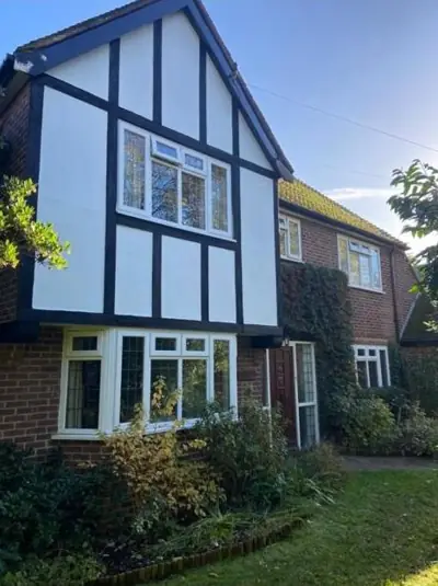 Tudor-style house with black and white exterior repainted