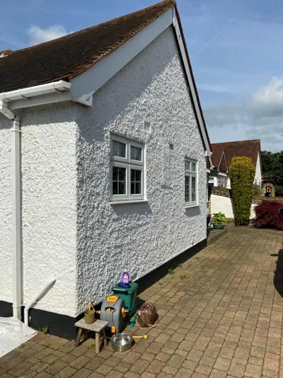Roughcast bungalow repainted white