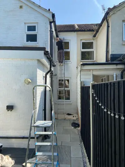 Side passage of a house with repainted render