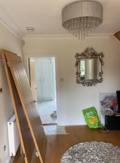 Hallway with chandelier and freshly painted walls