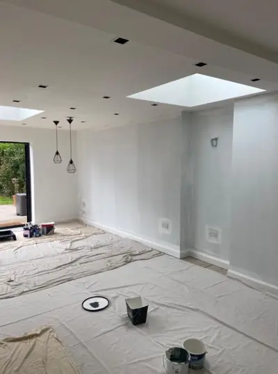 Open-plan kitchen extension with roof lantern being decorated