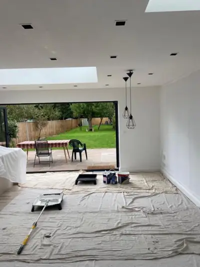Open-plan kitchen extension with roof lantern being decorated