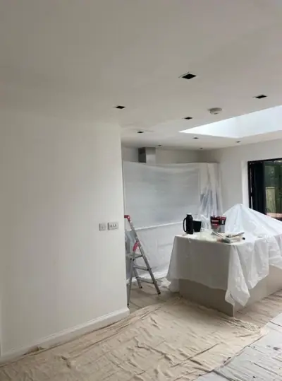 Open-plan kitchen extension with roof lantern being decorated