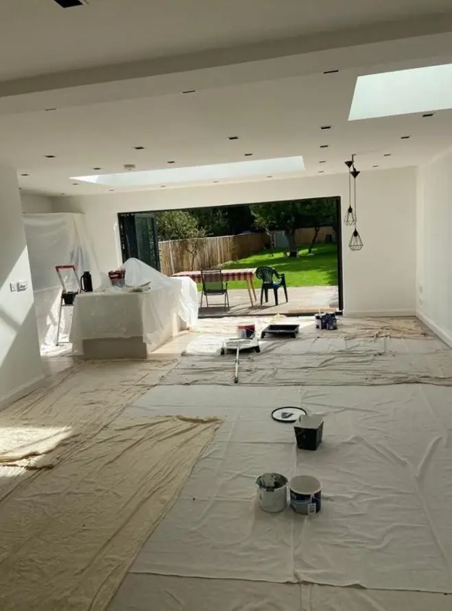 Open-plan kitchen extension with roof lantern being decorated