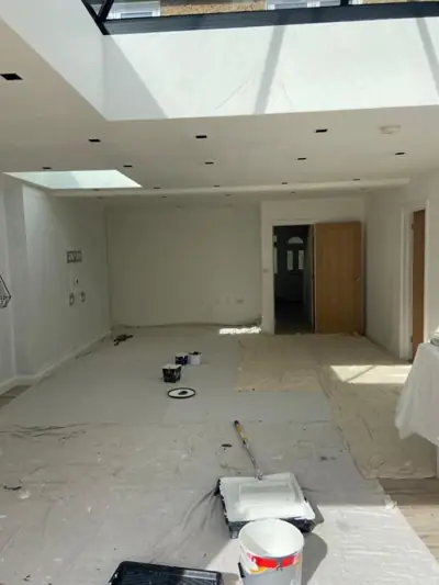 Open-plan kitchen extension with roof lantern being decorated