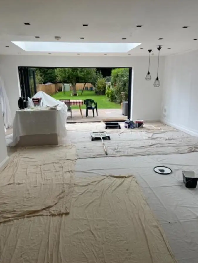 Open-plan kitchen extension with roof lantern being decorated
