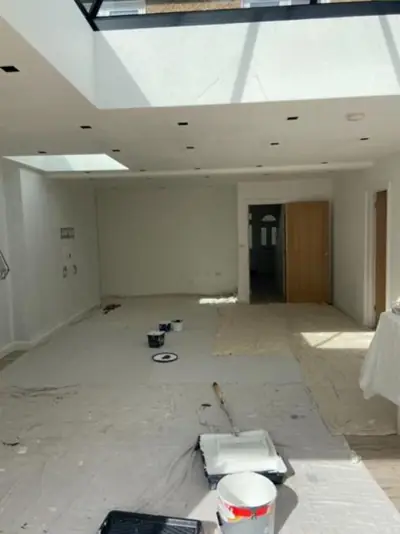Open-plan kitchen extension with roof lantern being decorated