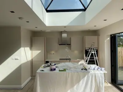 Open-plan kitchen extension with roof lantern being decorated