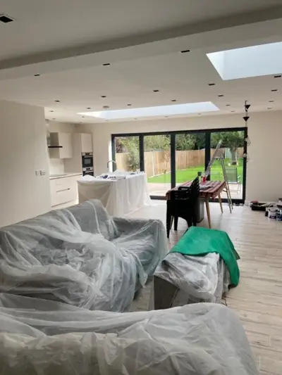 Open-plan kitchen extension with roof lantern being decorated
