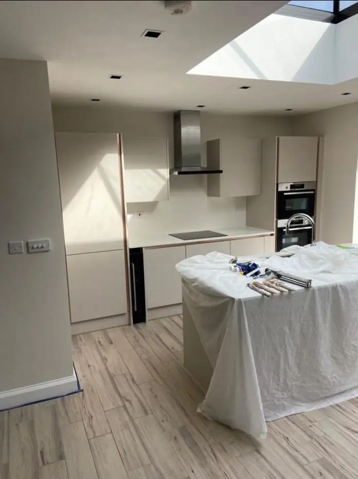 Open-plan kitchen extension with roof lantern being decorated
