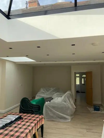 Open-plan kitchen extension with roof lantern being decorated