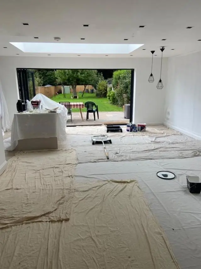 Open-plan kitchen extension with roof lantern being decorated
