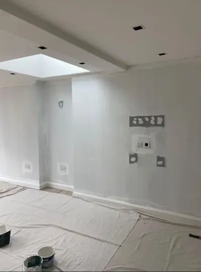 Open-plan kitchen extension with roof lantern being decorated